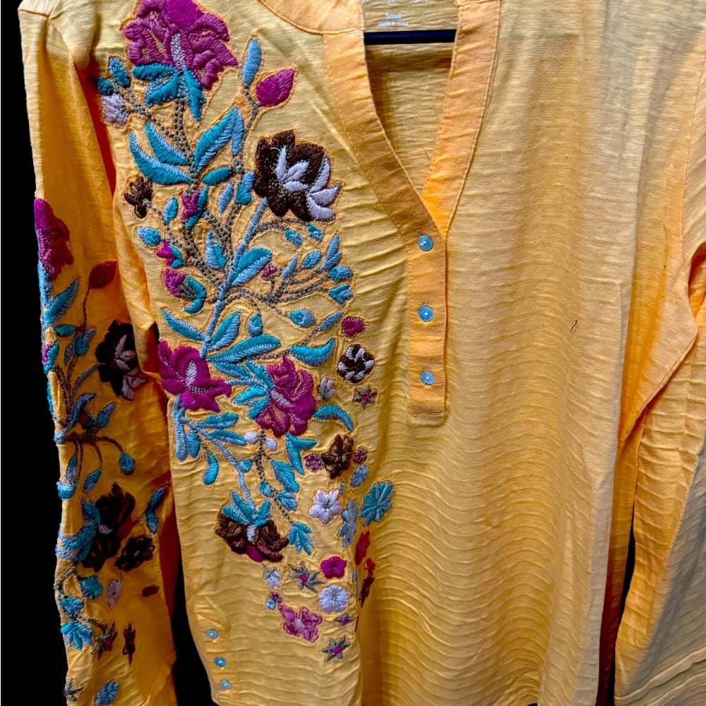Orange top with embroidery on arm and front